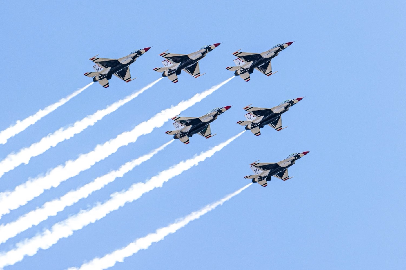 A precise formation of aircraft holding uniform spacing while trailing parallel smoke lines