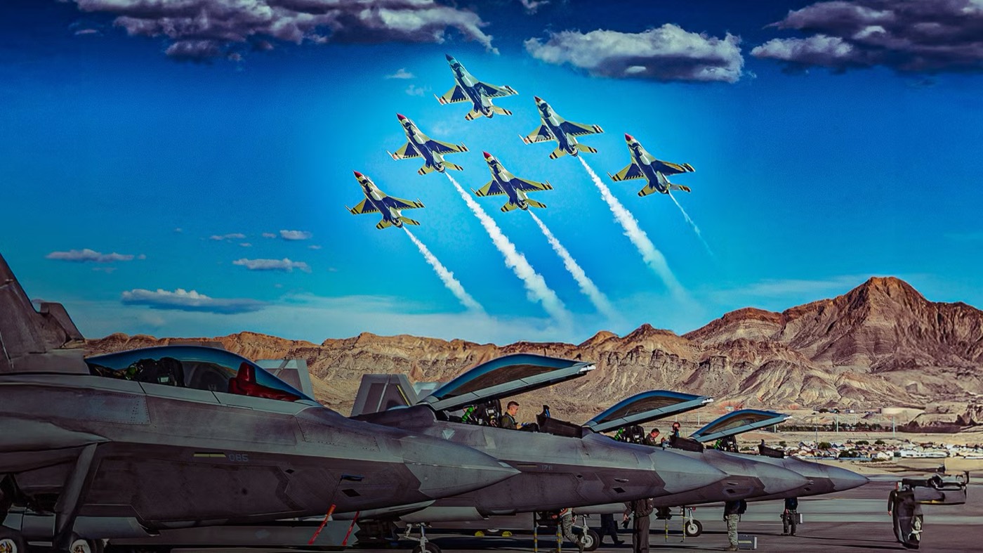 Aircraft on a flight line with a formation of jets flying overhead trailing smoke